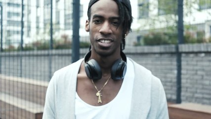 Handsome african american man looking at camera and smiling. - Powered by Adobe