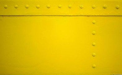 yellow metal plate with rivet for grunge or abstract background.