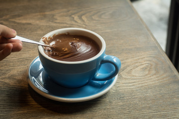 Blue Cups of hot Chocolate drink on dark wooden background. Morning time. Holiday concept
