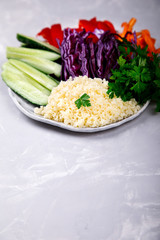 Buddha Bowl Vegetarian .Raw Vegetables and  in Couscous a one bowl.Food or Healthy Diet concept.Super Food.Copy space for Text. selective focus.