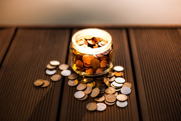Saving money in jar, saving for future concept