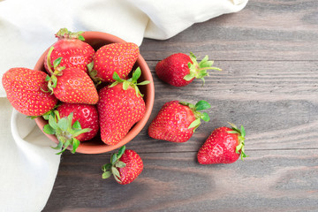 Red strawberries in white bowl