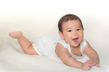 portrait of asian baby isolated on the bed