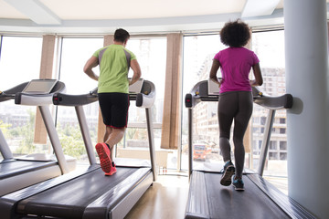 Fototapeta na wymiar people exercisinng a cardio on treadmill in gym