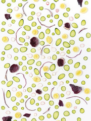 Vegetable pattern. Pattern of cucumber, lemon, red cabbage and radish. Sliced cucumber slices on a white background. Abstract food background.