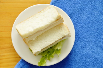 sandwich stuffed pork bologna and green oak on dish