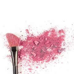 Makeup brush on white background, with traces of powder