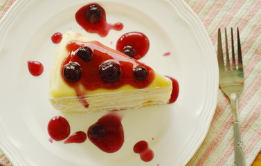 crape cake dressing blueberry sauce on dish
