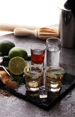 Selection of alcoholic drinks on rustic stone plate