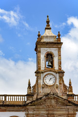 Fototapeta na wymiar Ancient tower with bell and clock in the historic city of Ouro Preto, Minas Gerais