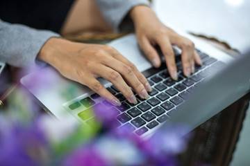 woman's hands using laptop with blank screen on table in offie