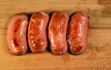 Fried sausages on a wooden table