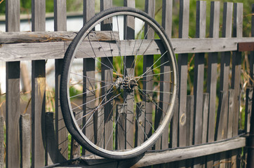 Bicycle wheel. Old bicycle tyre on wooden fence.