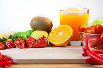 Healthy concept with mixed fruits and vegetables on wooden background