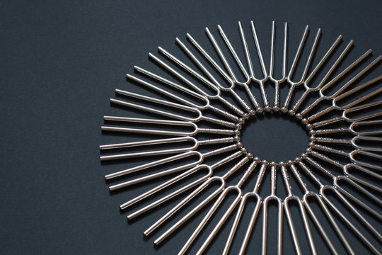 Tuning fork round pattern on a black background