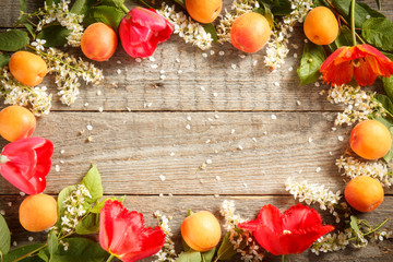 Spring flowers, apricots on wooden background. Copy space. Selective focus.