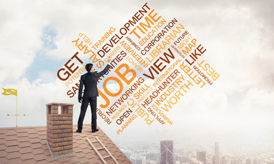 Young businessman standing on house roof and writing leadership 