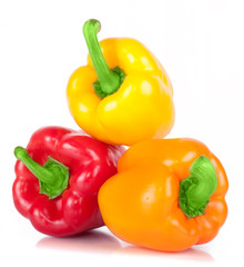 .three sweet pepper red, orange, and yellow with bright green стрволом with white light and the water drops diet pepper, isolated on white background