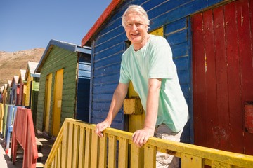 Portrait of man standing at beach hut