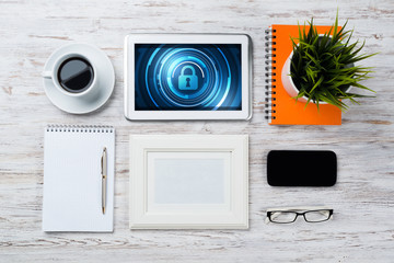 Web security and technology concept with tablet pc on wooden table