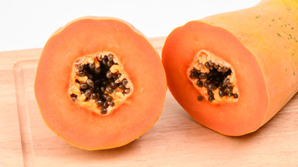 Papaya fruit section cut on wooden block