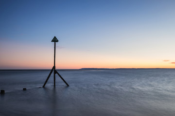 Beautiful vibrant Spring sunset long exposure beach landscape