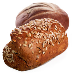 Loaf of rye bread soft tasty poured by sunflower seeds of a sunflower and a round loaf on a background isolated on a white background.