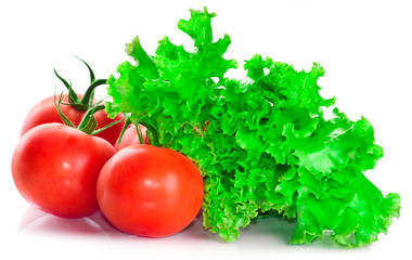 Vegetable vitamin collection from ripe red tomatoes and fresh leaves of salad isolated on a white background