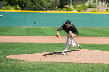 Mens' baseball pitcher throwing the curveball with maximum spin.  