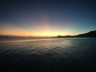 Naklejka premium Beautiful sunset covering the plage Matira into beautiful colours, Bora Bora, Tahiti, French Polynesia