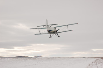 Fototapeta na wymiar Low-flying plane screw closeup on a background a winter landscape. Back view.