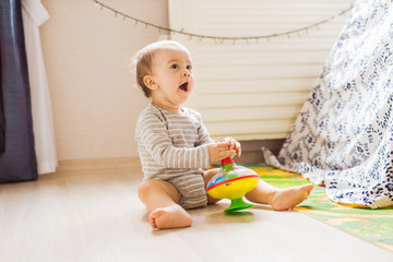 child boy toddler playing with toy indoors