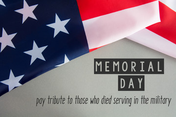 Fototapeta na wymiar Text Memorial Day on American flag background. toned image card 