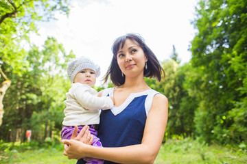 Mixed race happy mother with baby girl outdoors portrait