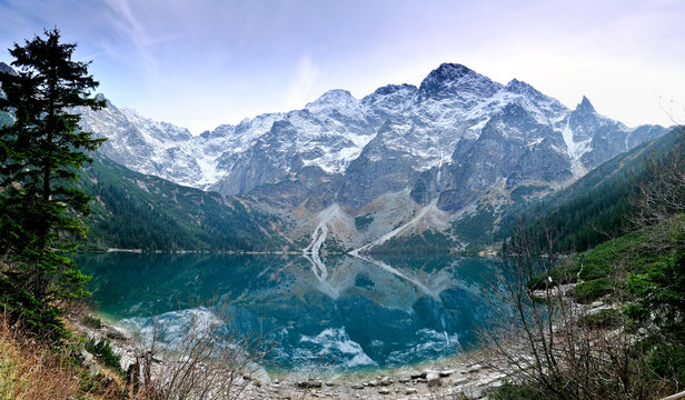 Morskie Oko lake in autumn colours with fresh snow covered peaks, High Tatra Mountains, Poland
