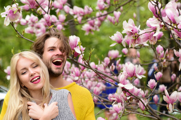 Fototapeta premium happy couple in love in spring magnolia flowers