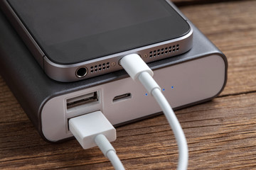 Smartphone charging with power bank. © Arkadiusz Fajer