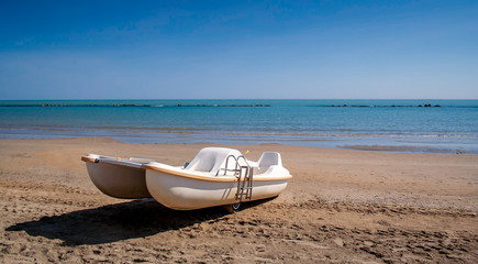 White paddle boat on the beach, Pescara, Italy