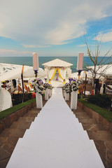white path to a wedding arch to the seas