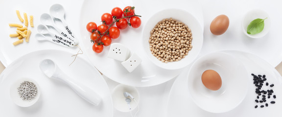 empty white plates of different sizes and food ingredients
