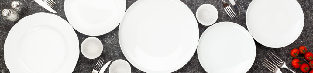 Table setting. Plates and cutlery. On a dark background. Form for advertising banner and restaurants