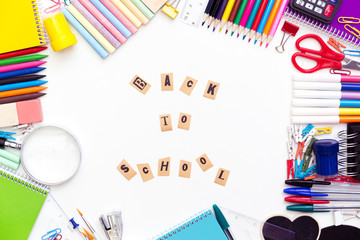 Desk with stationary and with Back to school sign.
