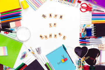 Desk with stationary and with Back to school sign.