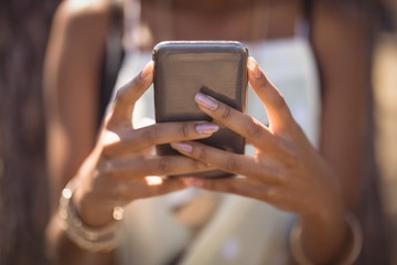 Midsection of woman using smart phone