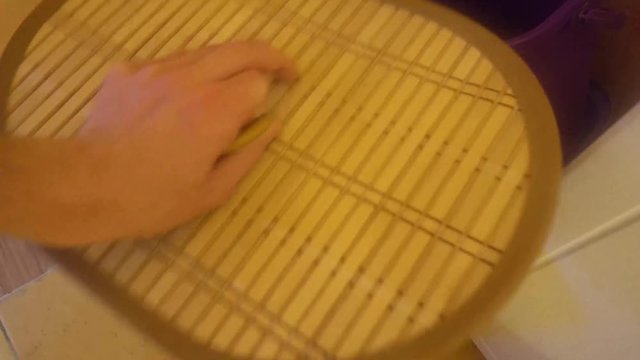 the human hand raises the lid of the basket for dirty Laundry and throws the dirty clothes.