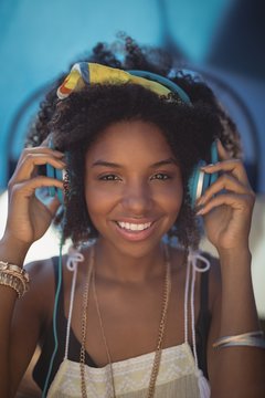 Portrait of smiling woman listening music