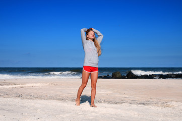 Healthy woman running on the beach, doing sport outdoor, freedom, vacation