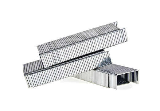 Close up stack of metal staples for stapler on a white background