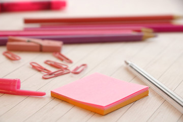 Pink office stuff: note paper, paper clips and pencils