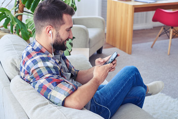 Bearded guy relaxing and listening to music